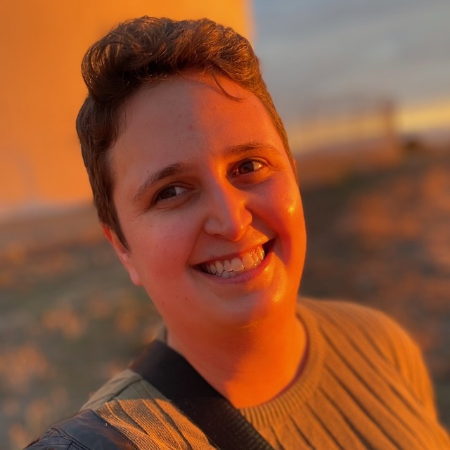 Maggie smiling in golden sunset light